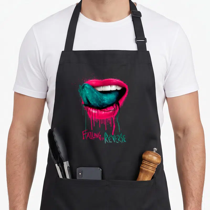 Tablier de cuisine noir avec une illustration de lèvres roses, vert et texte Falling in Reverse.