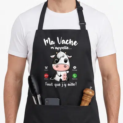 Tablier de cuisine noir avec illustration d'une vache mignonne et texte Ma Vache m'appelle Faut que j'y aille en blanc.