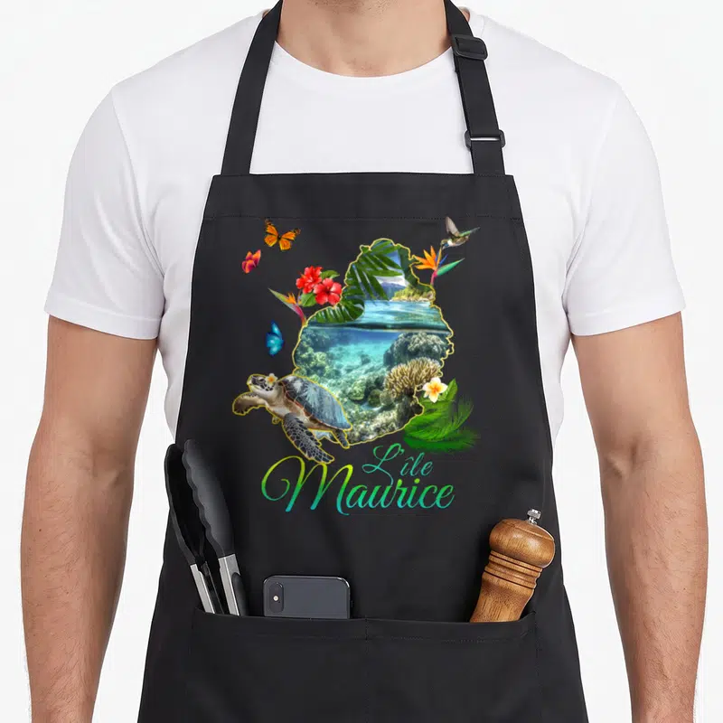 Tablier de cuisine noir avec carte île Maurice, tortue, coraux, fleurs rouges et papillons colorés.