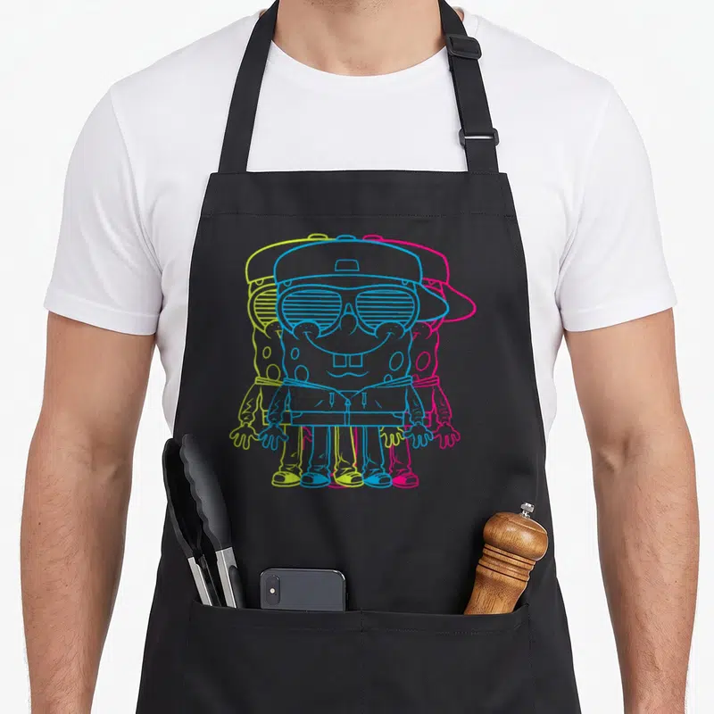 Tablier de cuisine noir avec illustration de Bob l'éponge aux contours cyan, jaune et rose vif portant une casquette et des lunettes.