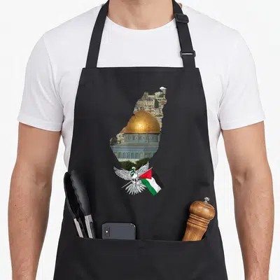 Tablier de cuisine noir avec dôme doré, silhouette de carte et colombe tenant un drapeau tricolore.