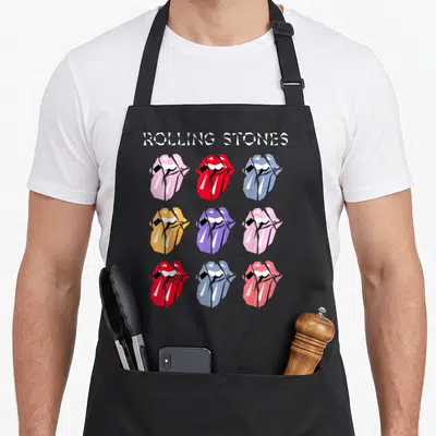 Tablier de cuisine noir avec neuf logos de lèvres multicolores et l'inscription Rolling Stones en haut.