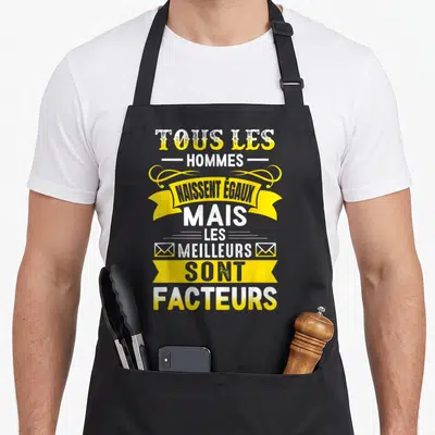 Tablier de cuisine noir avec citation tous les hommes naissent égaux mais les meilleurs sont facteurs en jaune et blanc.