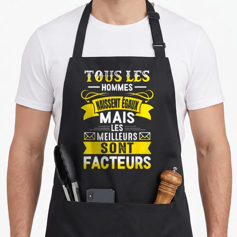 Tablier de cuisine noir avec citation tous les hommes naissent égaux mais les meilleurs sont facteurs en jaune et blanc.