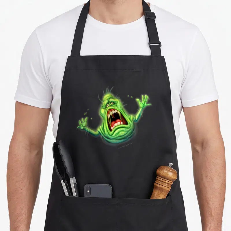 Tablier de cuisine noir avec un portrait coloré de Slimer vert la bouche grande ouverte en train de crier