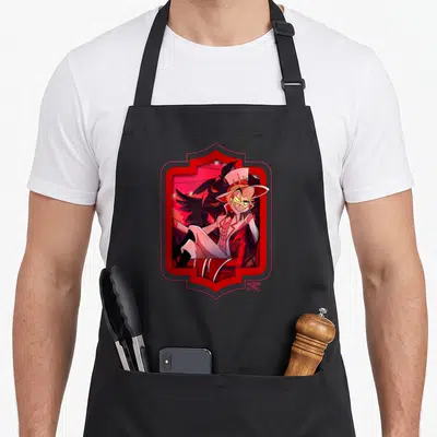 Tablier de cuisine noir avec illustration colorée de Lucifer au sourire large et chapeau rose.