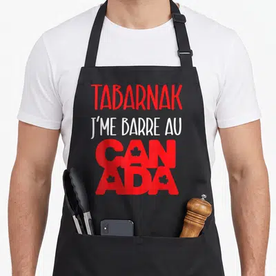 Tablier de cuisine noir avec le texte Tabarnak j me barre au Canada en rouge et blanc.