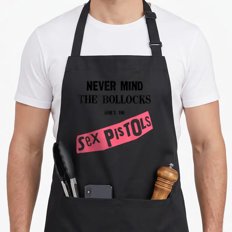 Tablier de cuisine noir avec l'inscription Never Mind The Bollocks Here's The Sex Pistols en rose et noir