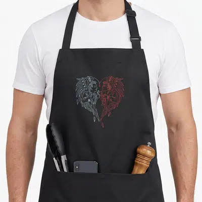 Tablier de cuisine noir avec deux anges stylisés face à face tenant une tasse, dessin linéaire bleu et rouge.