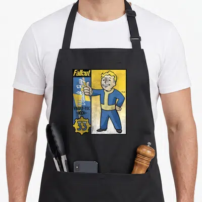 Tablier de cuisine noir avec illustration colorée de Vault Boy et logos Vault-Tec Fallout 33