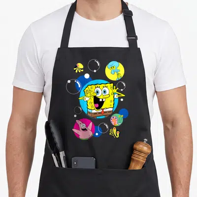 Tablier de cuisine noir avec Bob l'éponge souriant au centre, entouré de Patrick, Squidward et des méduses dans des cercles colorés.