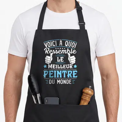 Tablier de cuisine noir avec inscription Voici à quoi ressemble le meilleur peintre du monde et deux pouces levés en blanc et bleu.