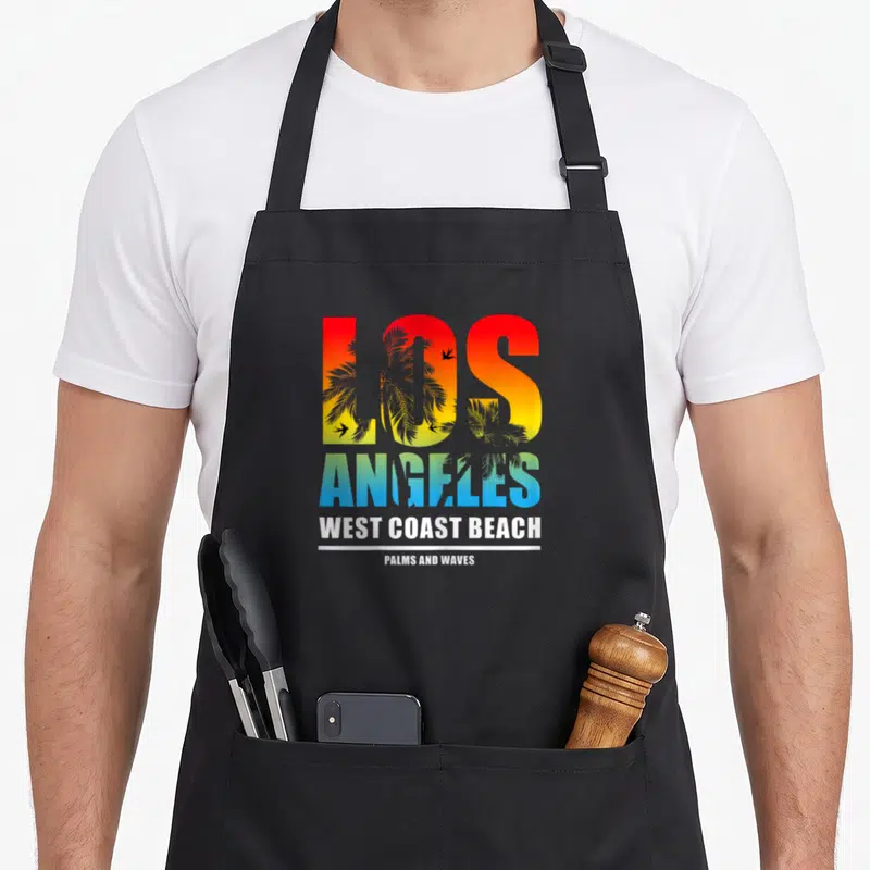 Tablier de cuisine noir avec inscription Los Angeles West Coast Beach et motifs de palmiers colorés.