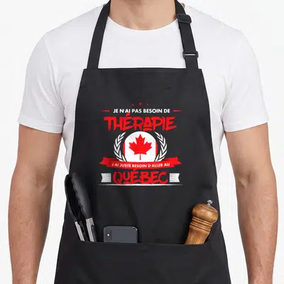 Tablier de cuisine noir avec inscription Je n'ai pas besoin de thérapie et un drapeau québécois stylisé.