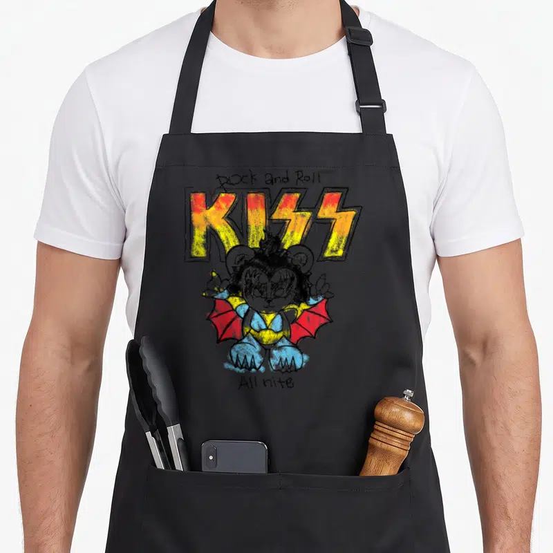 Tablier de cuisine noir avec ours en style KISS In the Lines et texte Rock and Roll All nite imprimé en couleurs vives.