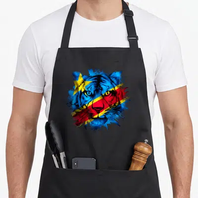 Tablier de cuisine noir avec un tige stylisé aux couleurs du drapeau congolais et une étoile jaune sur le front.
