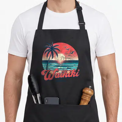 Tablier de cuisine noir avec illustration circulaire d'un coucher de soleil à Waikiki Hawaii palmier et oiseaux marins