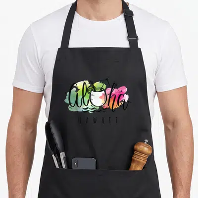 Tablier de cuisine noir avec Aloha Hawaii, cocktail coco, parapluie et taches d'aquarelle multicolores.