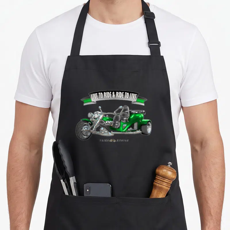 Tablier de cuisine noir avec illustration d'un tricycle vert et la phrase Live to ride et ride to live sur une banderole.