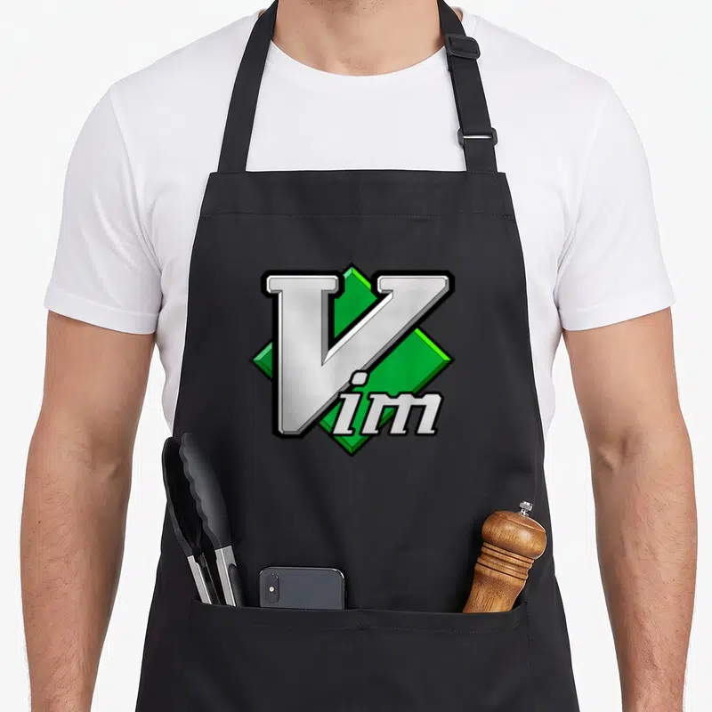 Tablier de cuisine noir avec logo Vim éditeur de texte script en vert et gris.