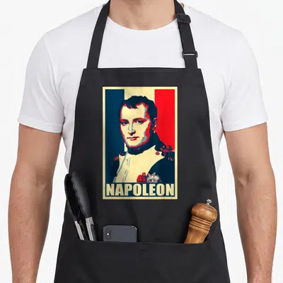 Tablier de cuisine noir avec portrait stylisé de Napoléon sur fond tricolore et le nom NAPOLEON en bas.