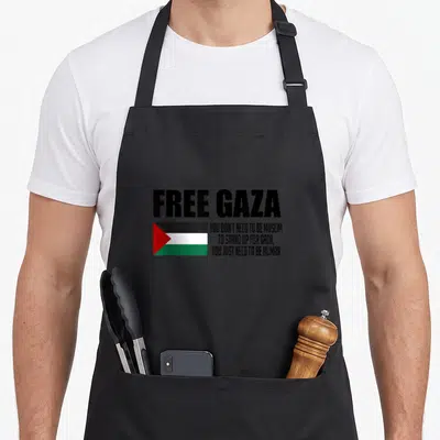 Tablier de cuisine noir avec inscription Free Gaza, drapeau palestinien et texte en anglais sur la solidarité humaine.