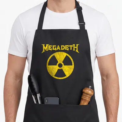 Tablier de cuisine noir avec inscription Megadeth et symbole de radiation jaune sur le devant.