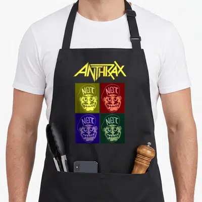 Tablier de cuisine noir avec logo Anthrax jaune et quatre visages Pop Art aux couleurs vives disposés en grille.