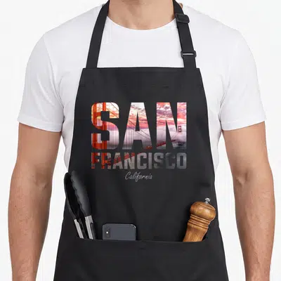 Tablier de cuisine noir avec l'inscription San Francisca et une image du pont Golden Gate Bridge au travers des lettres.