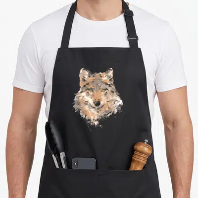 Tablier de cuisine noir avec tête de loup dessinée au pinceaux aux yeux jaunes vifs
