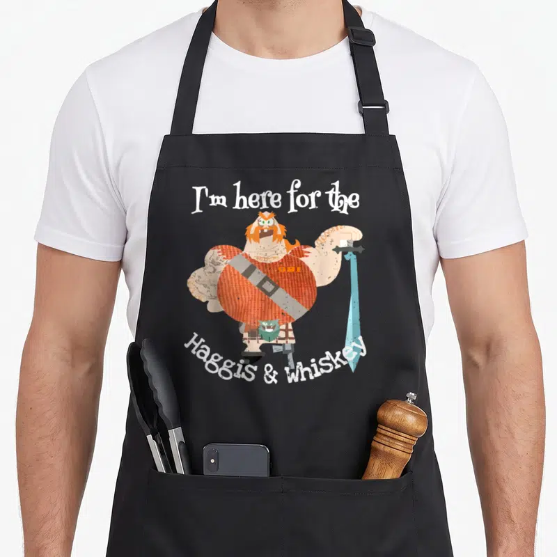 Tablier de cuisine noir avec illustration d'un guerrier écossais tenant une épée et le texte « I'm here for the Haggis and Whiskey ».