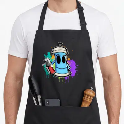 Tablier de cuisine noir orné d'un spray à graffiti bleu souriant tenant une petite bombe rouge sur fond de taches colorées.