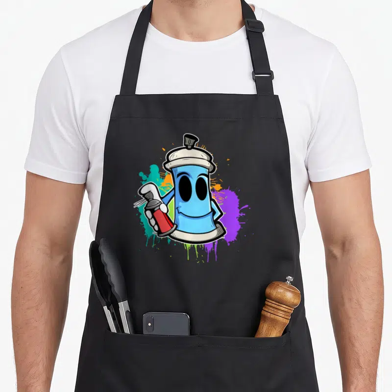 Tablier de cuisine noir orné d'un spray à graffiti bleu souriant tenant une petite bombe rouge sur fond de taches colorées.