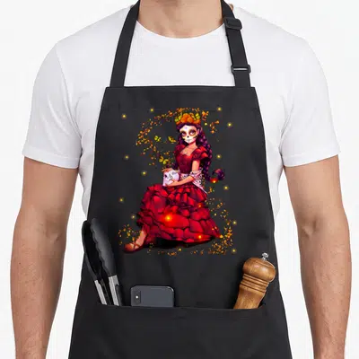 Tablier de cuisine noir avec illustration colorée d'une catrina en robe rouge tenant un crâne sous des papillons dorés.