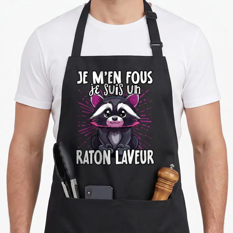 Tablier de cuisine noir avec un raton laveur mignon aux oreilles roses et le texte Je m'en fous je suis un raton laveur.