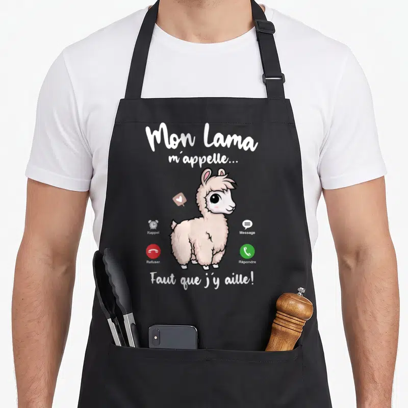 Tablier de cuisine noir avec illustration d'un lama rose et texte humoristique blanc