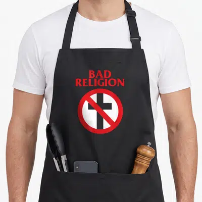 Tablier de cuisine noir avec l'inscription Bad Religion rouge et un signe d'interdiction sur une croix grise.