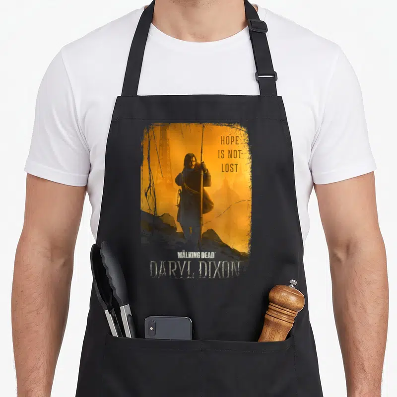 Tablier de cuisine noir avec illustration de Daryl Dixon, fusil, Tour Eiffel et texte Hope Is Not Lost sur fond orange.
