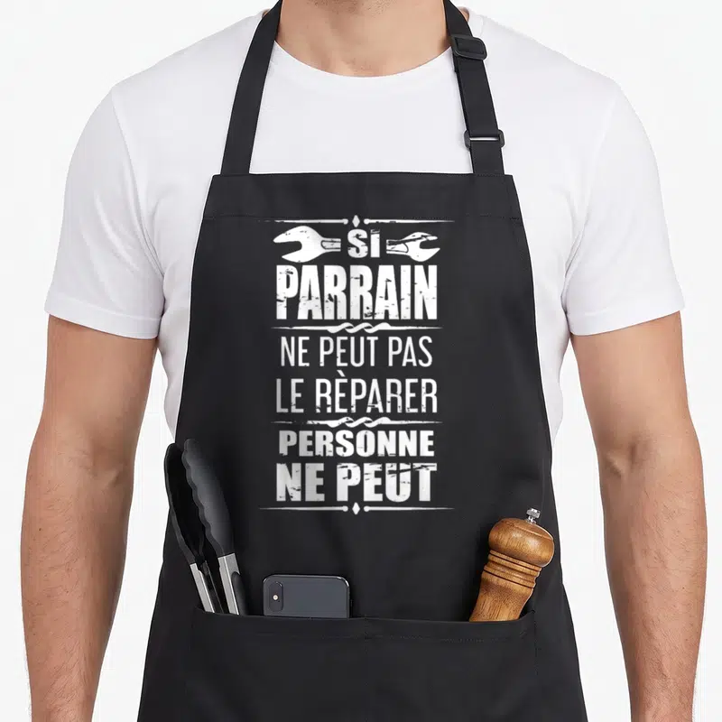 Tablier de cuisine noir avec inscription blanche Si Parrain Ne Peut Pas Le Réparer Personne Ne Peut encadrée par des clés anglaises.