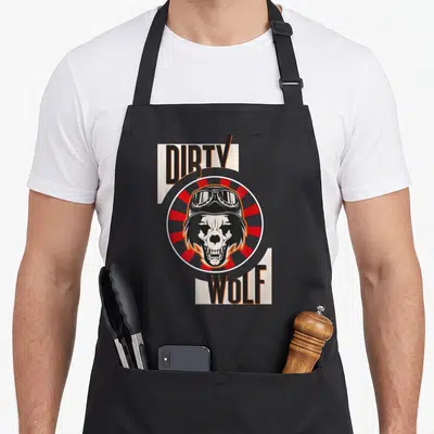 Tablier de cuisine noir avec un crâne de loup portant des lunettes et les mots DIRTV WOLF en lettres noires et orange.