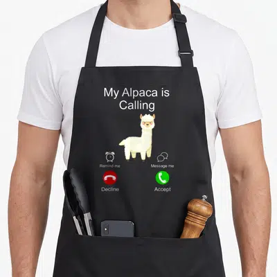 Tablier de cuisine noir avec un alpaca blanc et des boutons d'appel téléphonique rouge et vert.