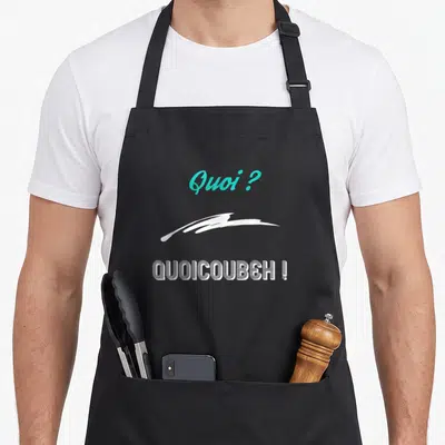 Tablier de cuisine noir avec inscription Quoi quoi coubeh en typographie blanche et turquoise