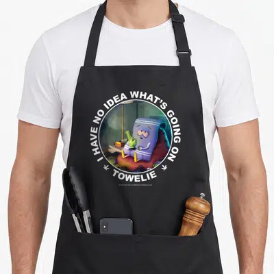 Tablier de cuisine noir avec l'illustration circulaire de Towelie tenant un bong vert et le texte blanc en bordure.