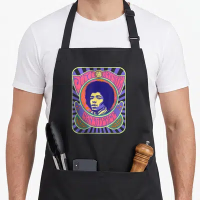 Tablier de cuisine noir avec un poster psychédélique coloré représentant le portrait de Jimi Hendrix au centre.