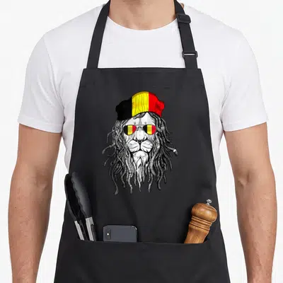 Tablier de cuisine noir avec illustration d'un lion aux dreadlocks portant un bonnet tricolore belge et des lunettes de soleil.