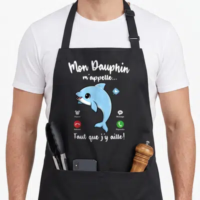 Tablier de cuisine noir avec un dauphin bleu dessiné et les textes Mon Dauphin m'appelle Faut que j'y aille.