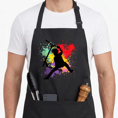 Tablier de cuisine noir avec silhouette trottinette freestyle et éclats de peinture multicolores en arrière-plan.