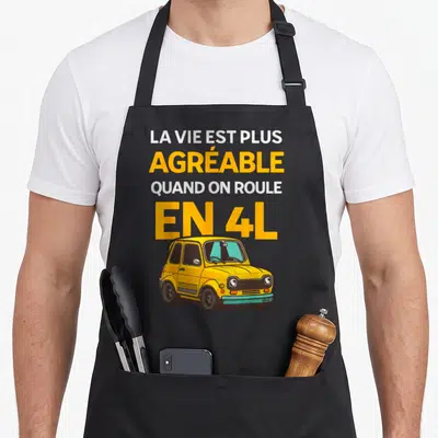 Tablier de cuisine noir avec une Renault 4L jaune et le texte La vie est plus agréable quand on roule en 4L