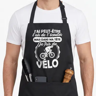Tablier de cuisine noir avec une illustration blanche d'un cycliste et le texte Je fais du vélo.