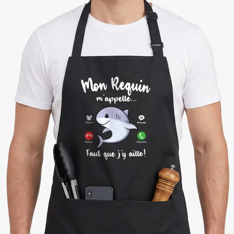 Tablier de cuisine noir avec un requin cartoon et des icônes d'appel téléphonique en français.